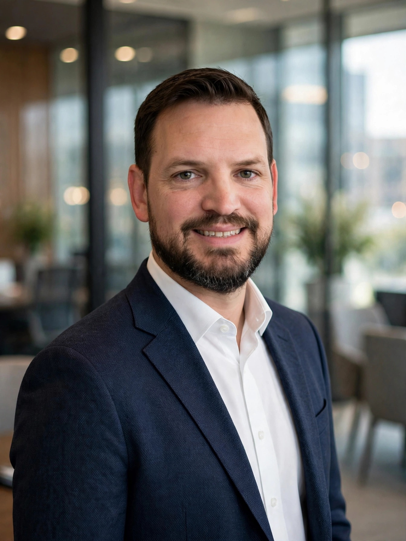 Jason McClaren — executive headshot in navy sport coat and white shirt